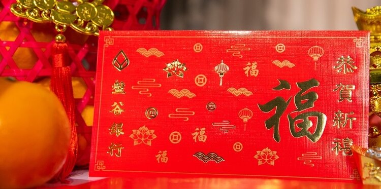 Bangkok Bank prepares Ang Pao envelopes depicting the Chinese character “Fu” for Chinese New Year 2024, the golden...